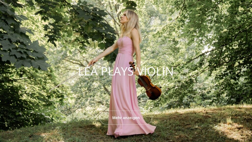 Lea spielt Violine vor der Albkappelle in Grünwinkel, Karlsruhe. Ein stimmungsvoller Moment inmitten der Natur.
